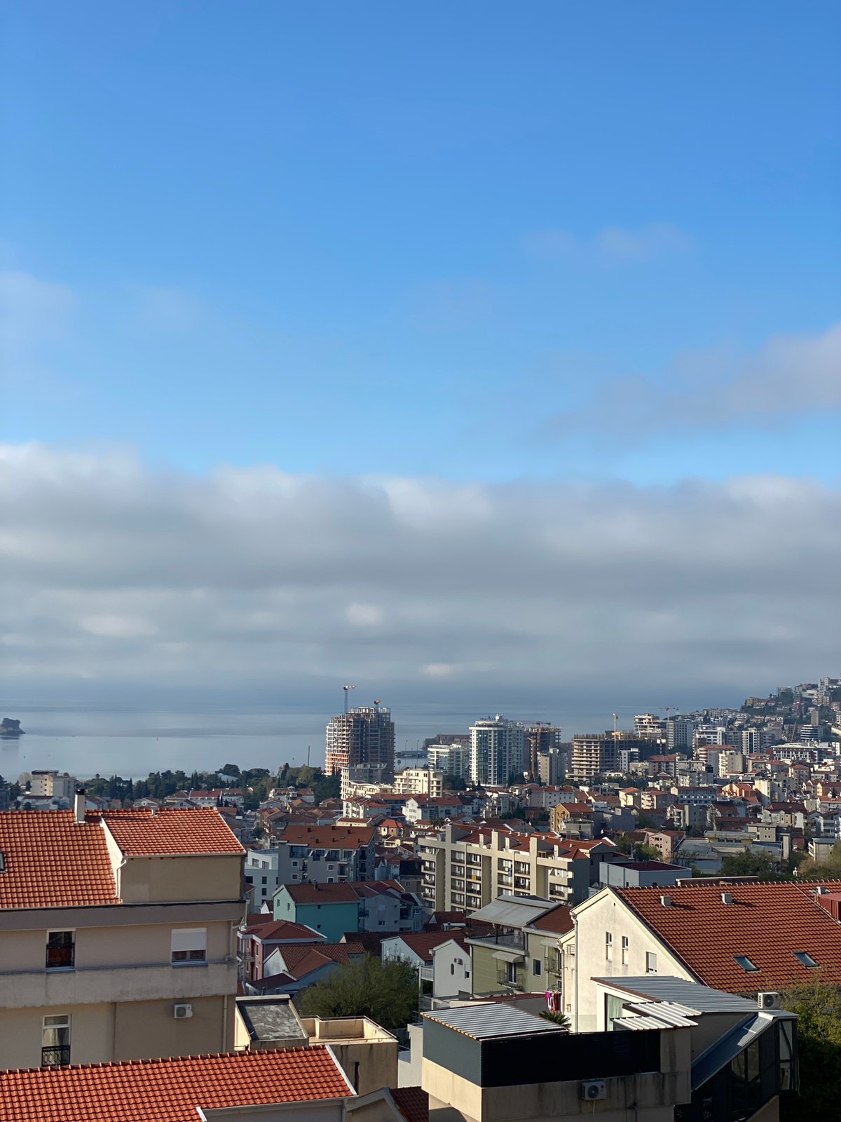 Morning aerial view captures Budva's red-roofed coastal cityscape