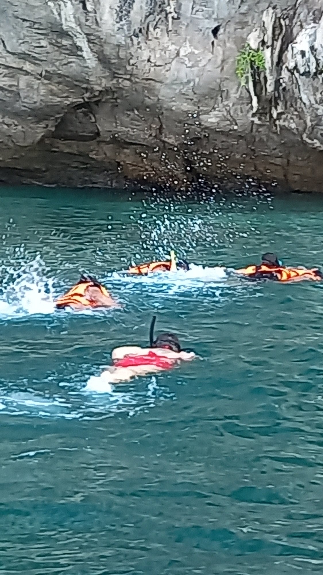 Snorkelers explore limestone cliffs in Ban Ao Nang waters