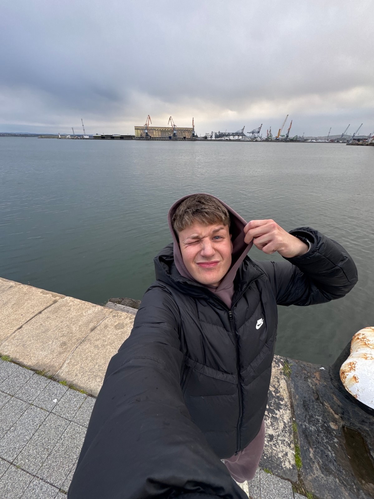 Fisherman spends rainy afternoon at Burgas harbor pier
