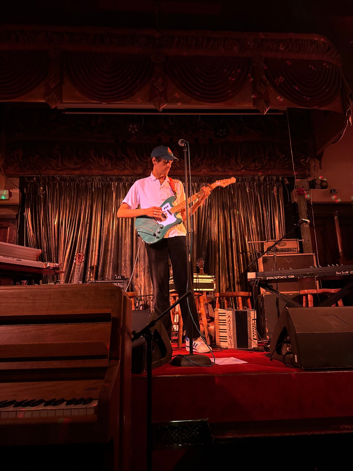 Musician performs live guitar set on London stage