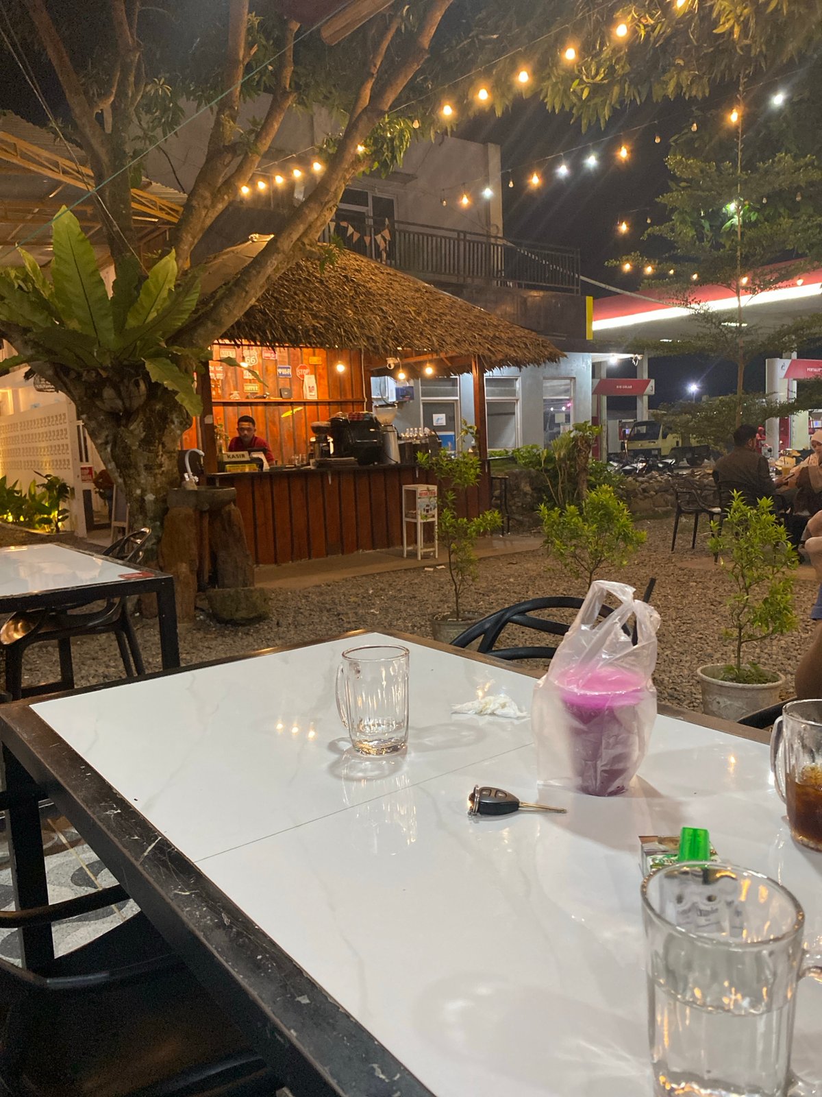 Nighttime café hangout near a mosque in an urban setting