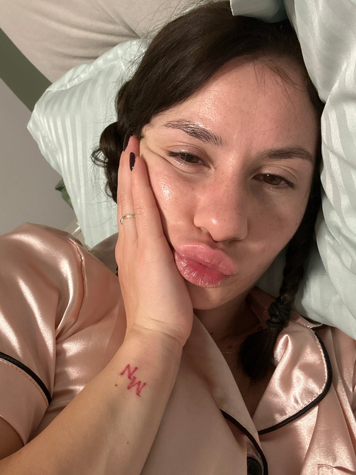 Woman in pink pajamas rests in bed in Plovdiv