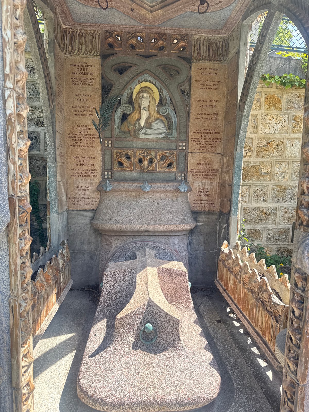 Visitor documents ornate tombs at Paris Montmartre Cemetery