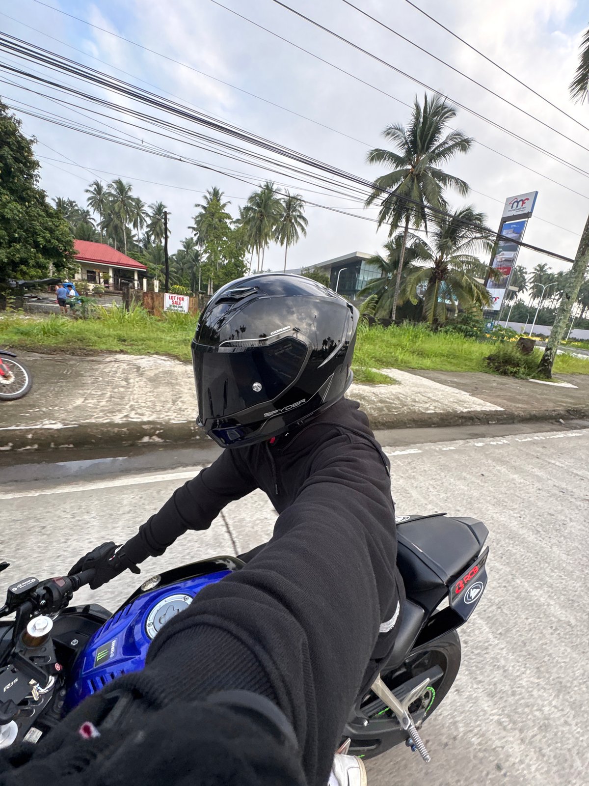 Evening motorcycle ride through palm-lined streets in Tagum City