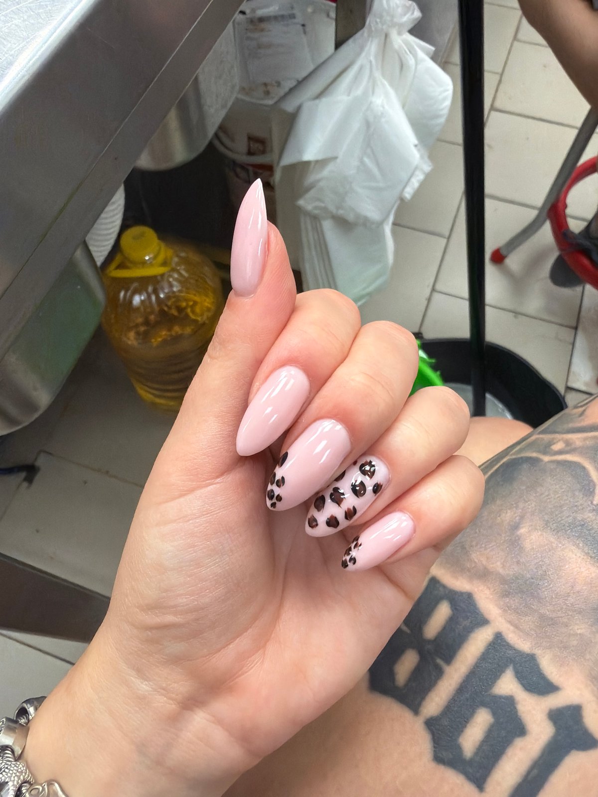 Nail art and tattoo details in a Plovdiv back-of-house setting