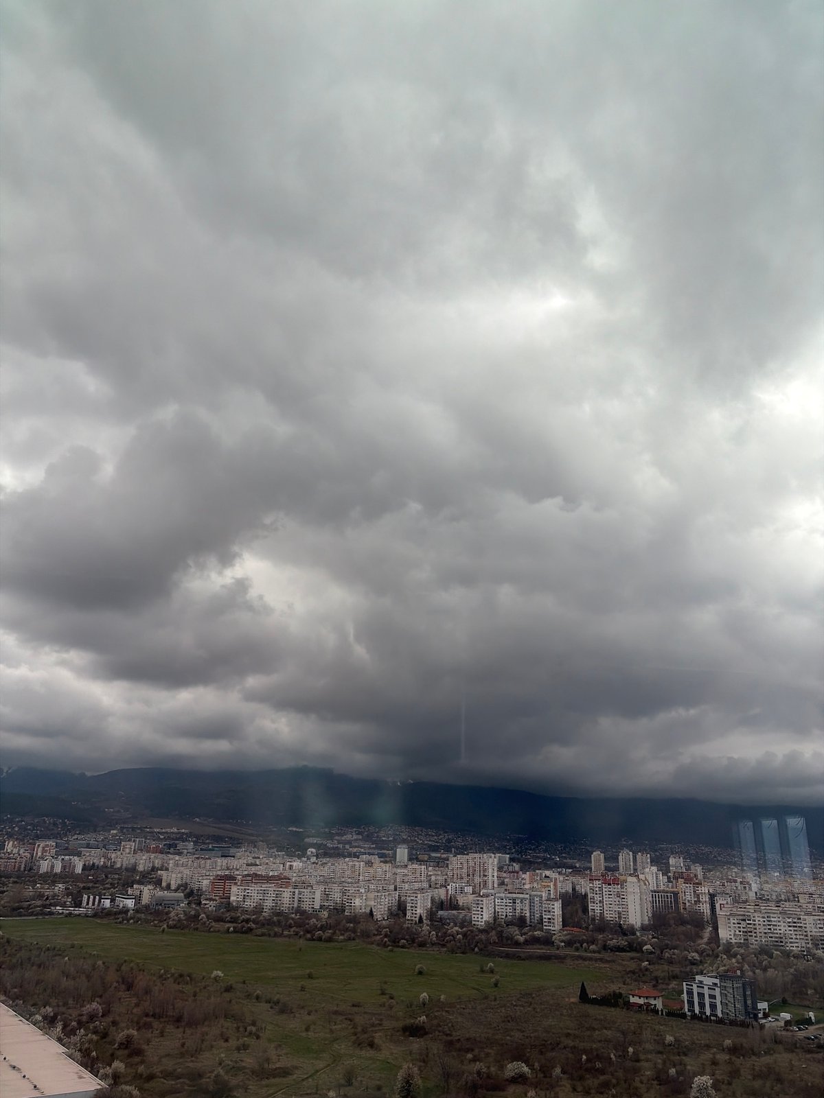Overcast skies observed over dense Sofia cityscape from elevation