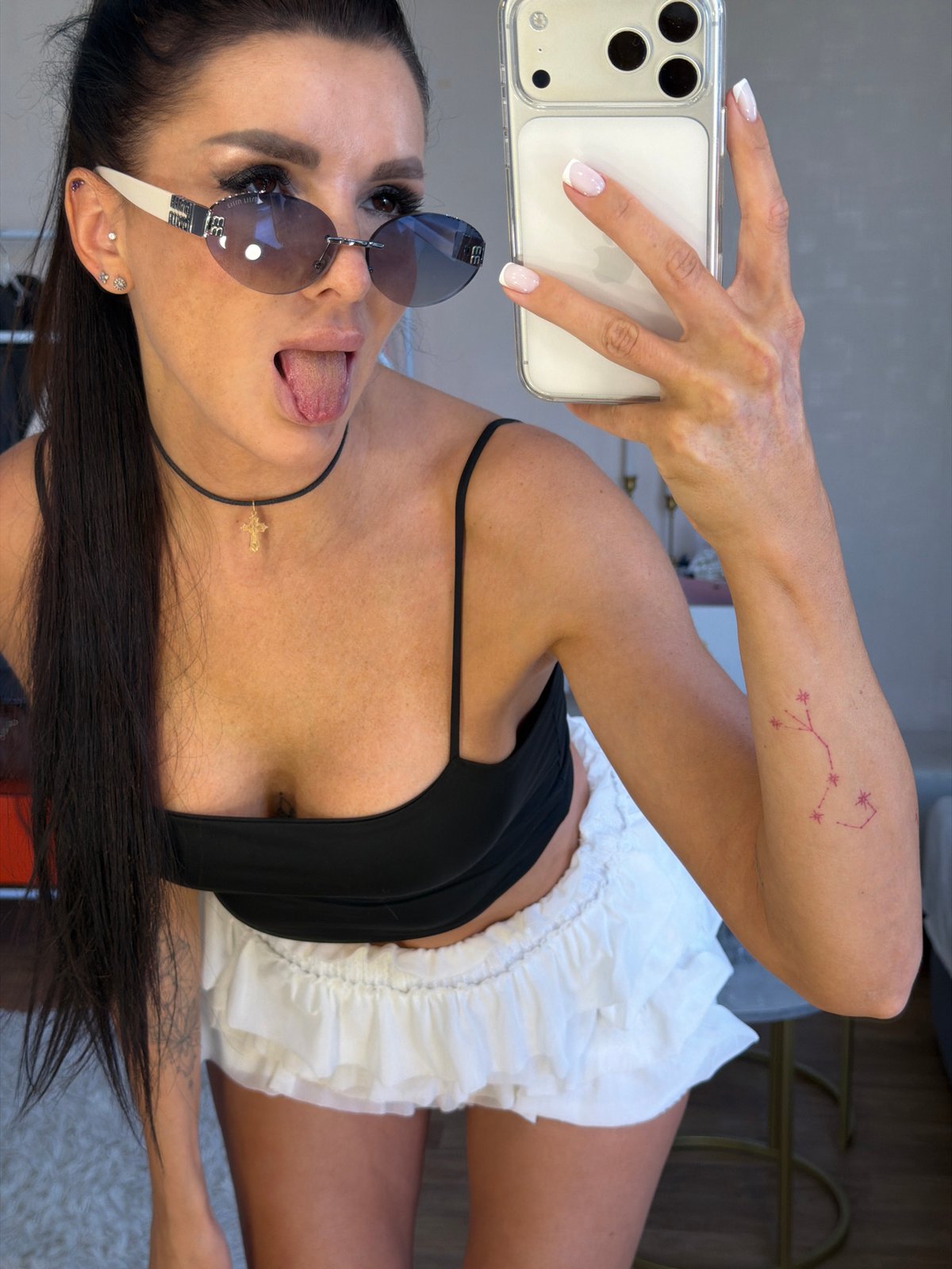 Casual home selfie with sunglasses and a playful expression