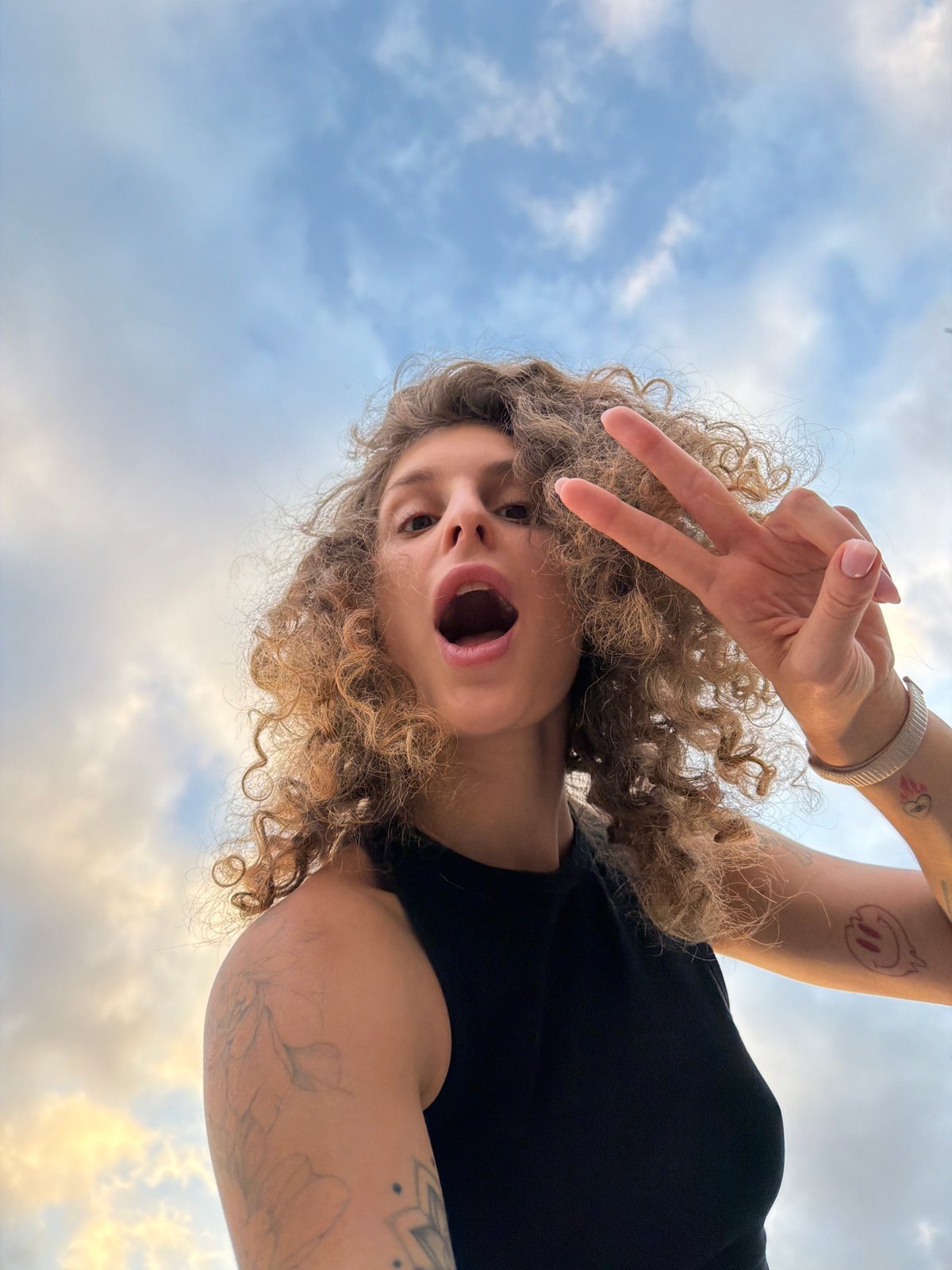 Woman takes creative photo session during dramatic sunrise in Bali