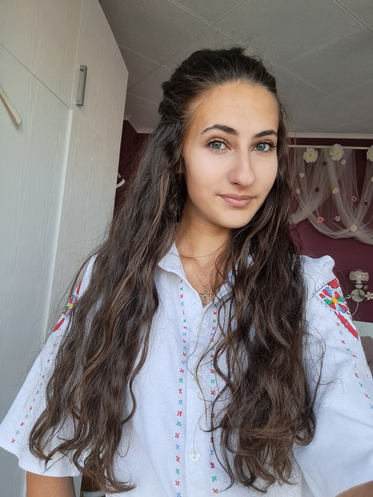 Candid portraits in an embroidered white blouse, indoors