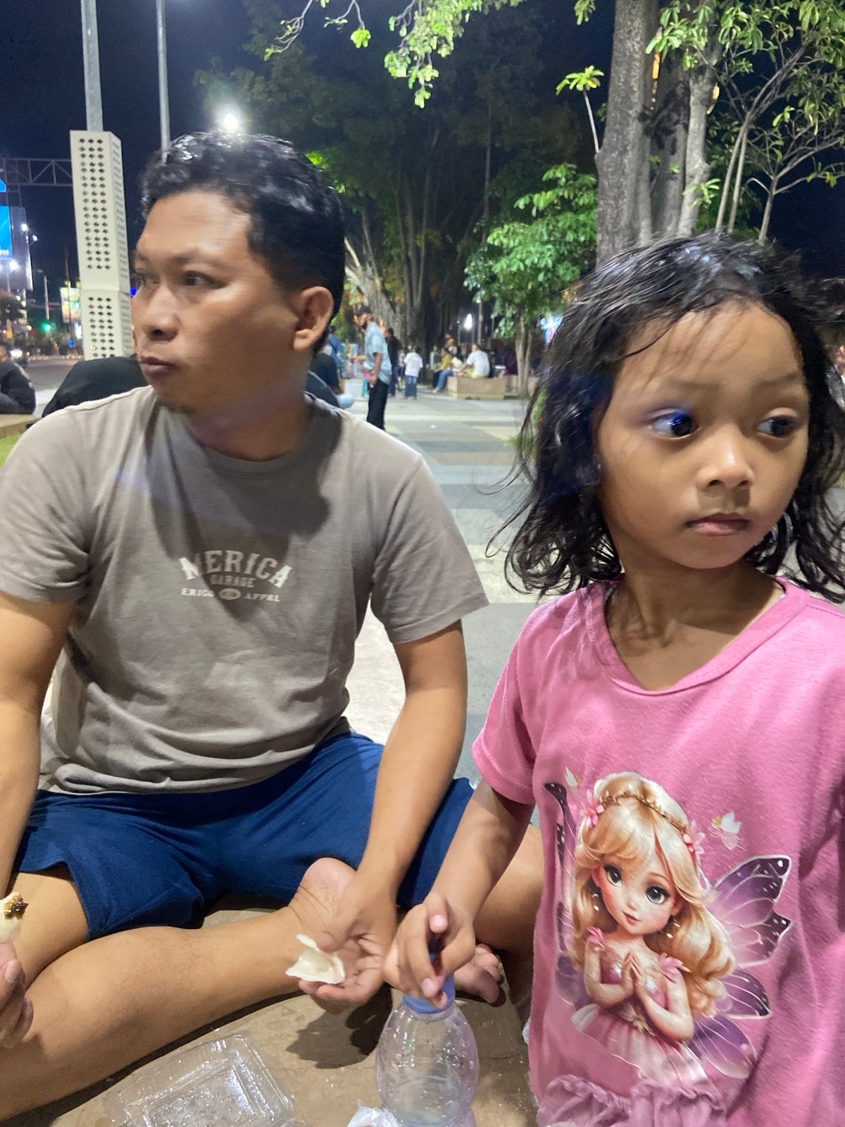 Evening out at a Sidoarjo park: roller skates, snacks, and street life.