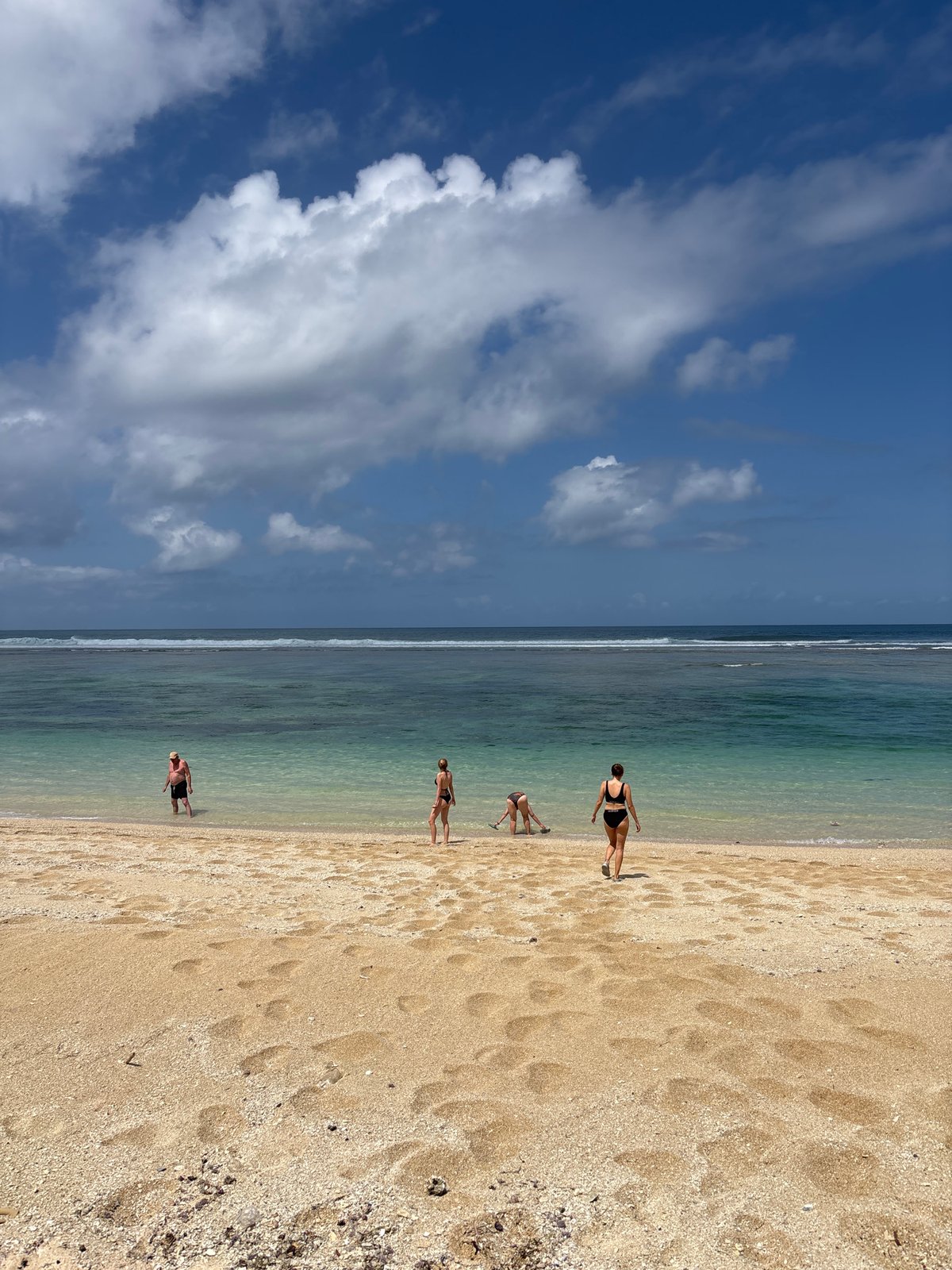 Paragliders soaring over Kuta Selatan's cliffs and beach