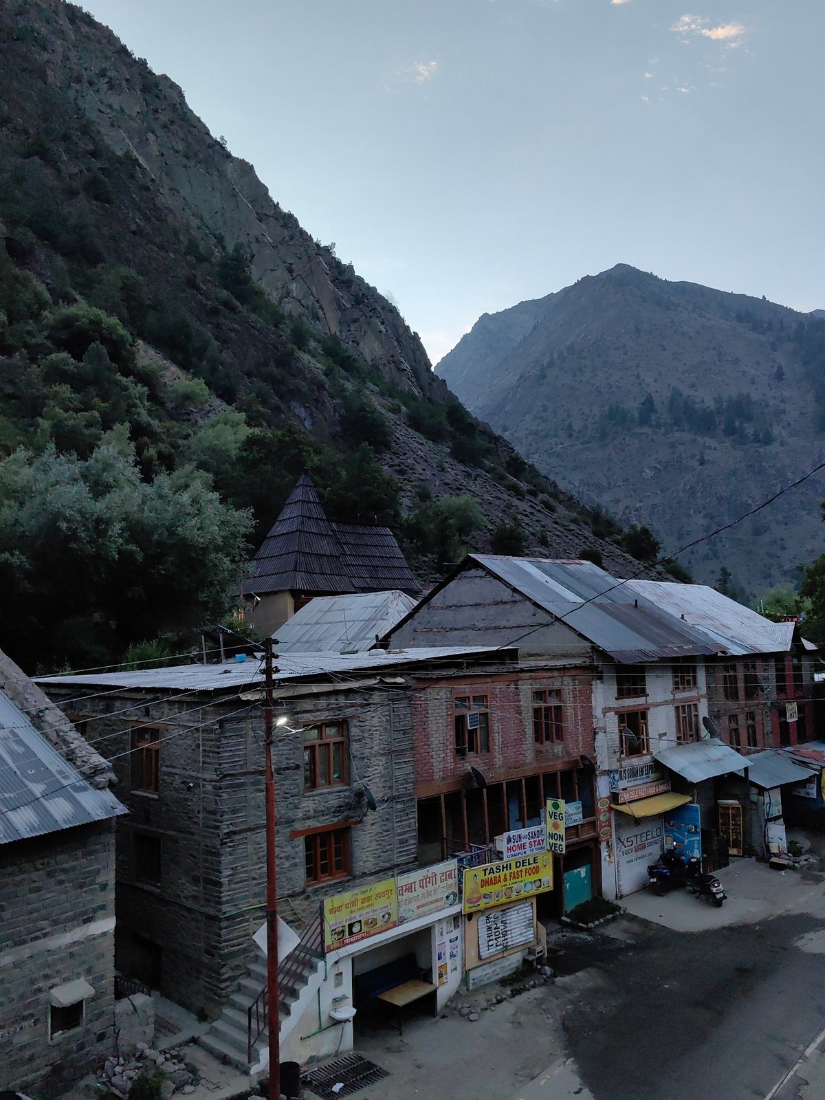 Mountain villages and hazy Himalayan peaks at dusk