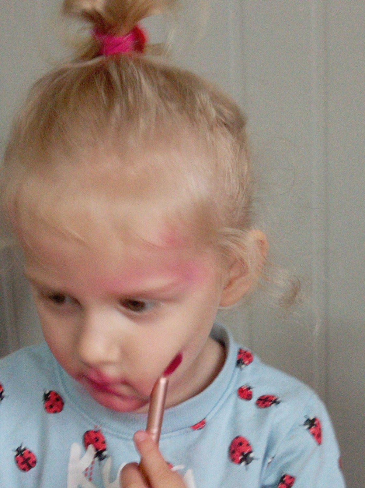 Child plays with makeup during morning hours in Artyom