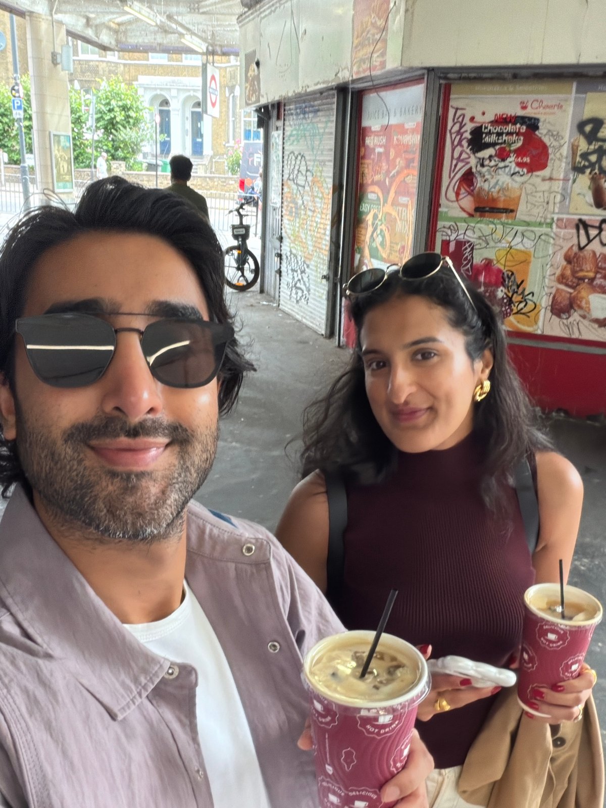 Iced coffee selfie in front of London graffiti wall