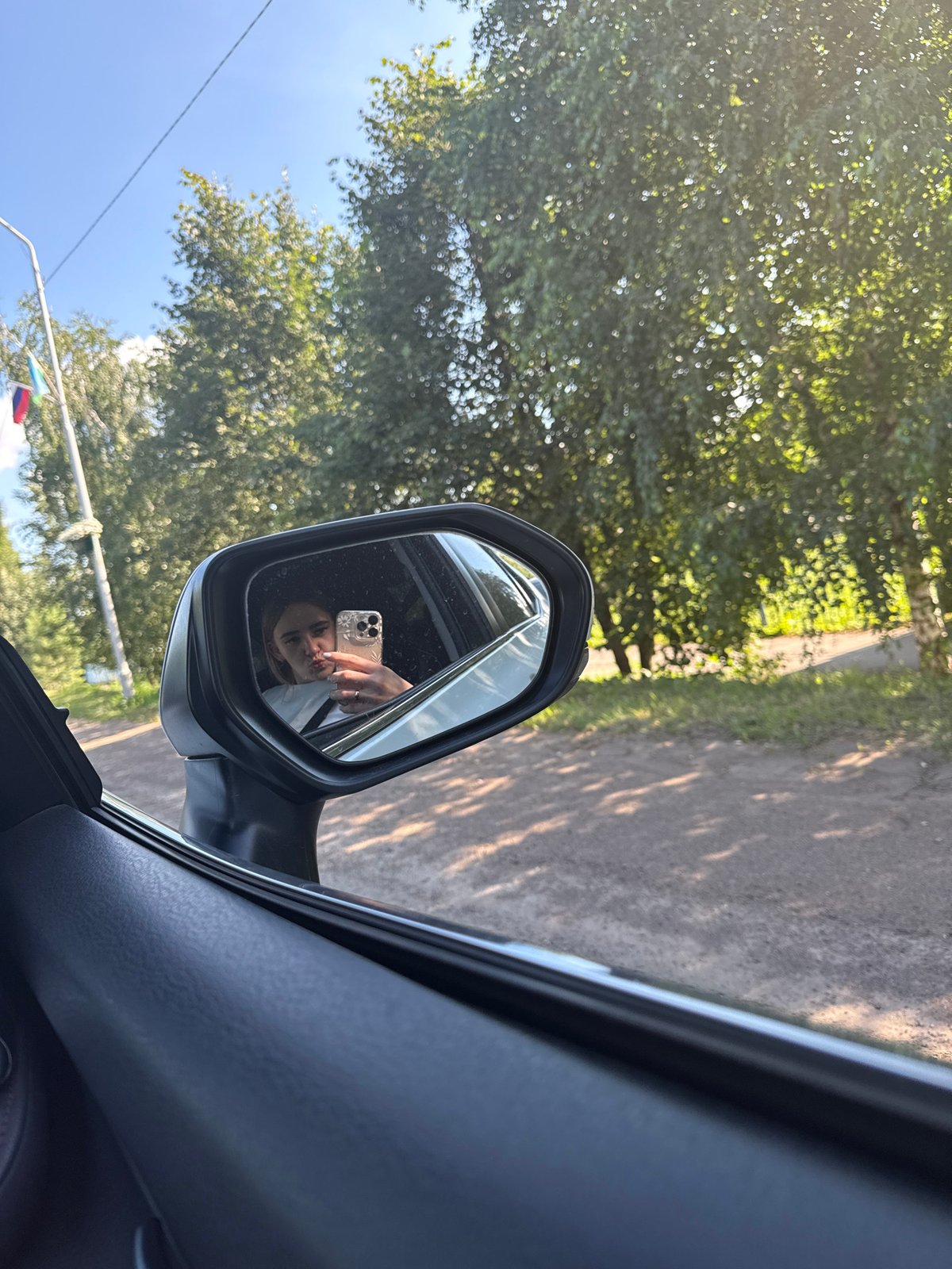 Car ride snapshots with fruit, figurines, and a mirror selfie