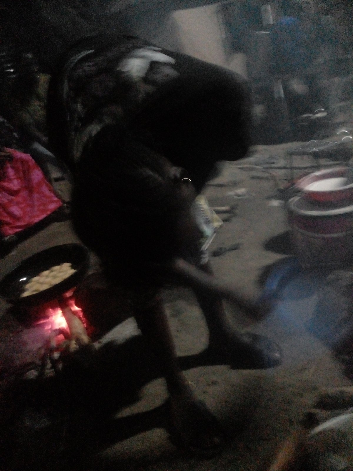 Nighttime street cooking over open fire in Langtang, Nigeria