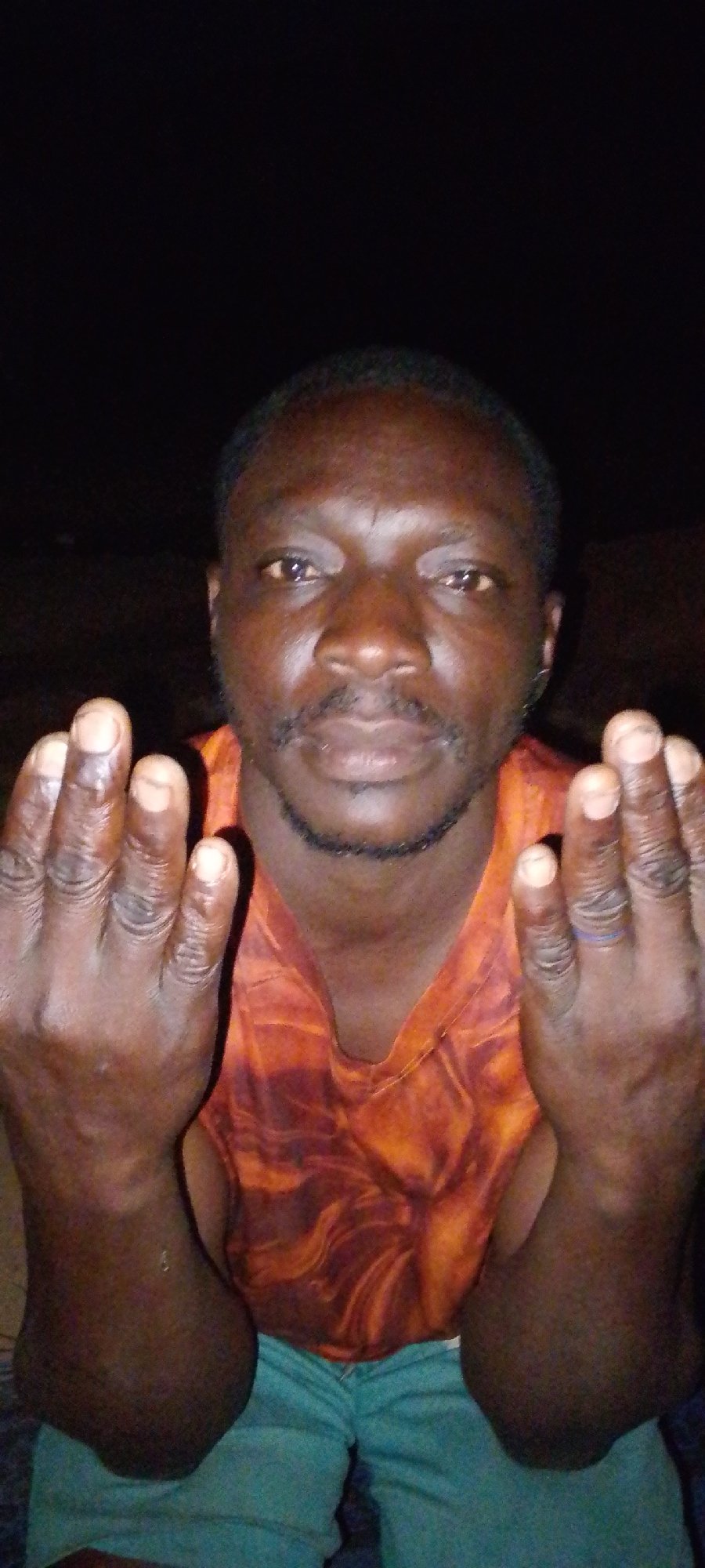 Man with raised palms observed in Jos, Nigeria