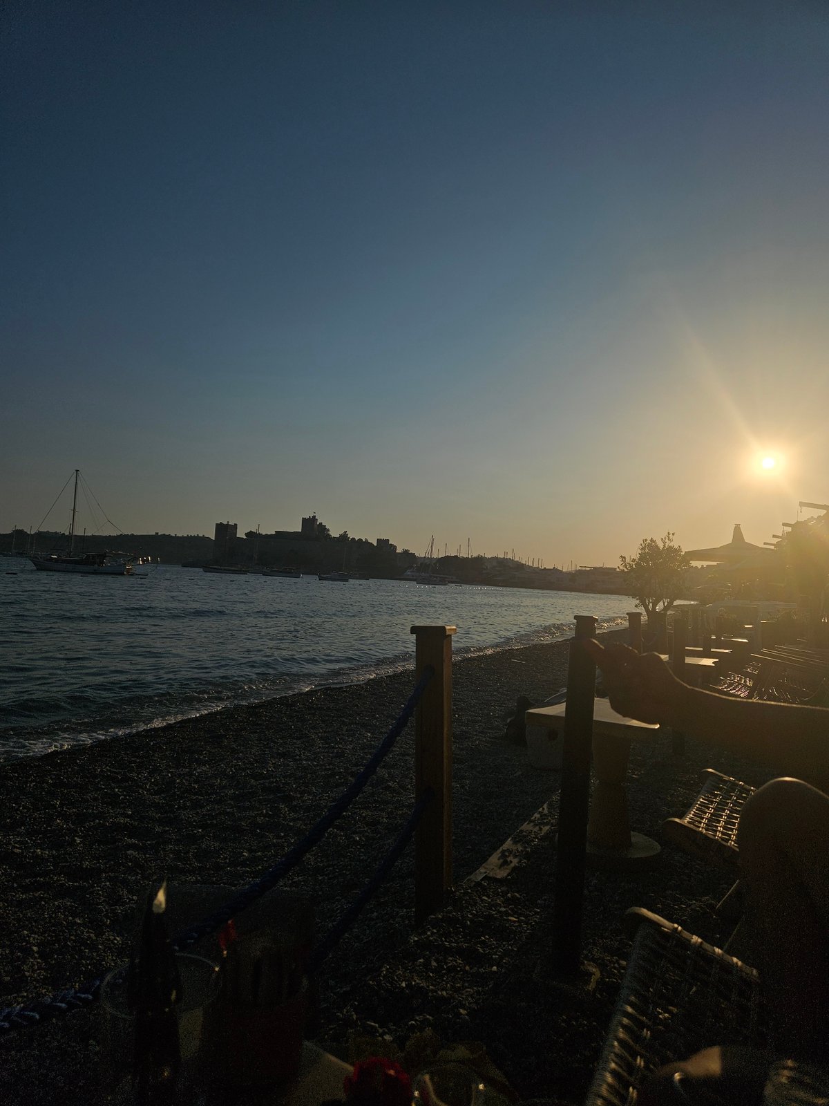 Sunset hour on a Bodrum pebble beach, Aegean in view