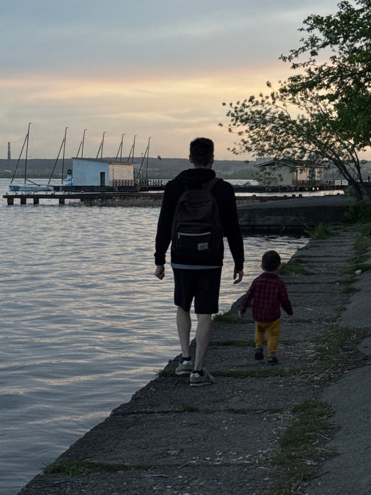 Father and child visit Izhevsk waterfront on spring afternoon