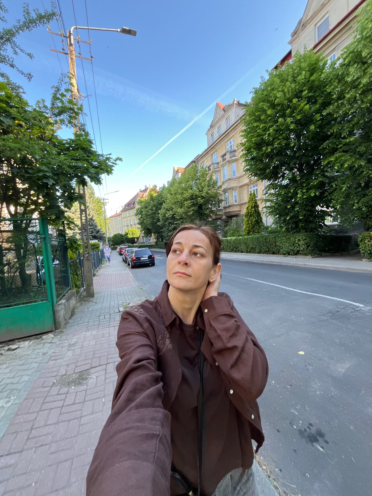 Woman documents morning coffee walk through urban construction zone