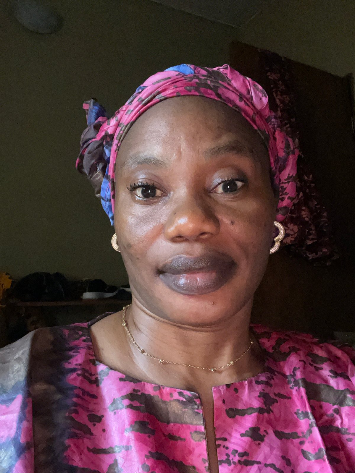 Portrait captured of woman in patterned headwrap in Narayi