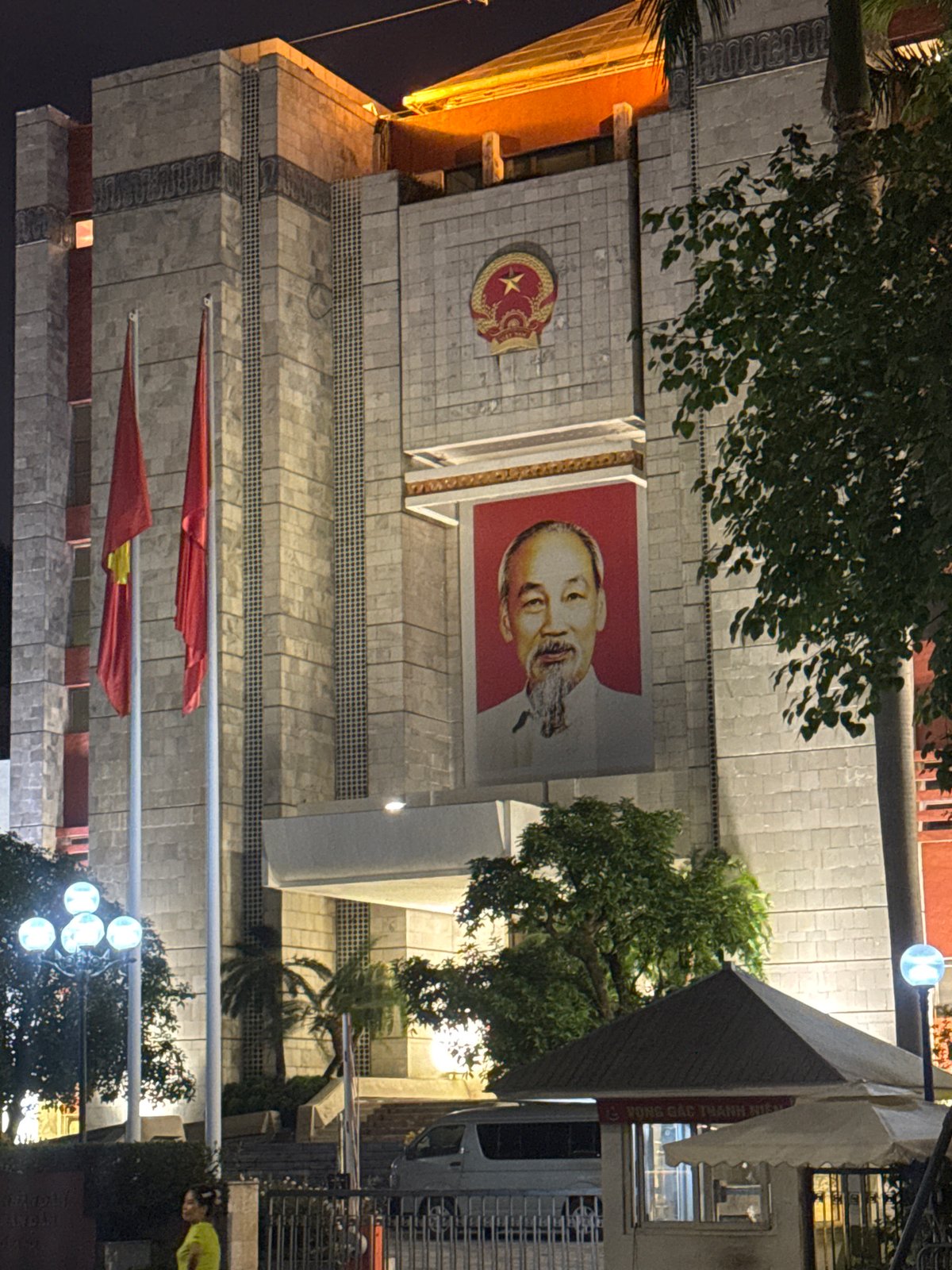Tourist takes selfie at illuminated Ho Chi Minh Mausoleum