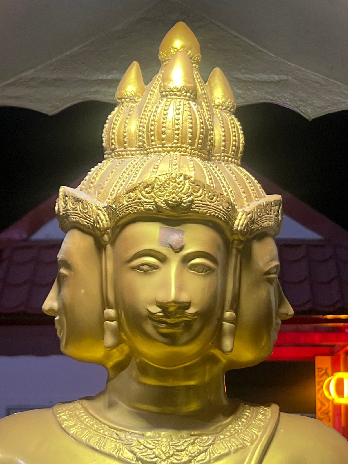 Golden four-faced Brahma statue at a Pa Khlok shrine