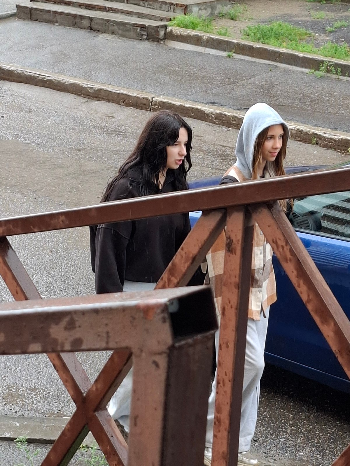 Rainy city streets, people moving through a wet urban day
