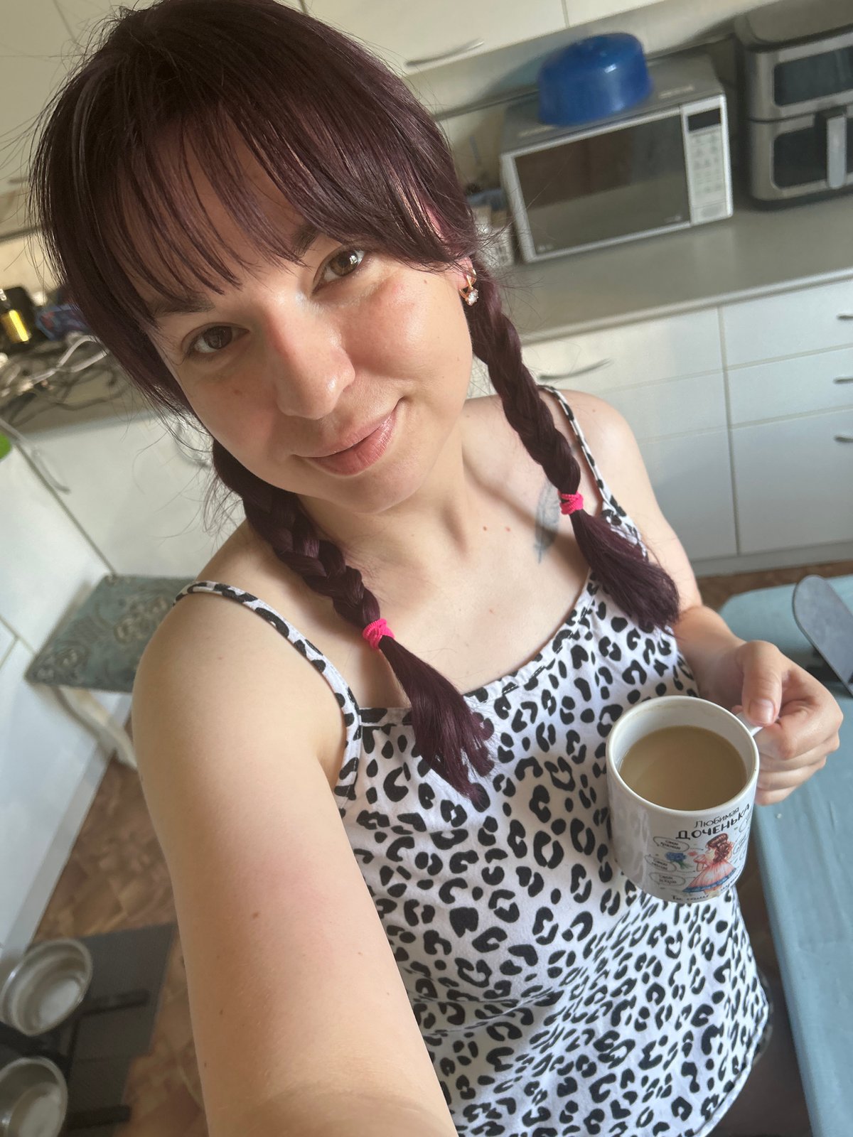 Woman photographed during morning routine in Russian kitchen