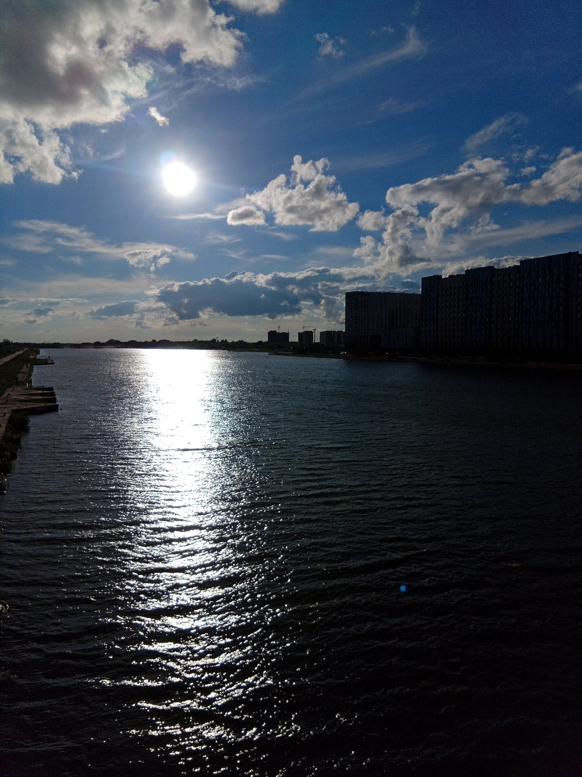 Sunny afternoon along an urban waterfront promenade