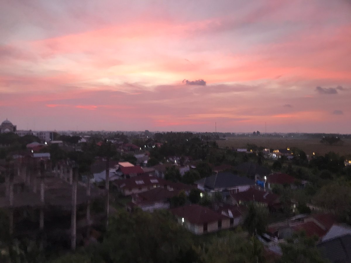 Sunrise/sunset vista captured over Cotbadatunong Indonesia residential landscape