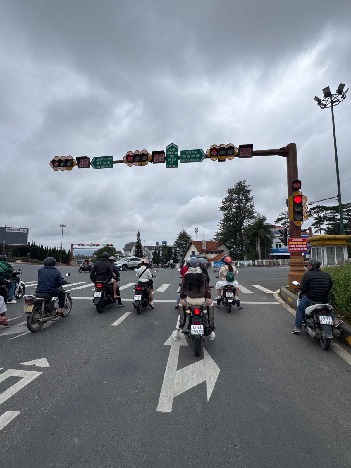 Motorcycle traffic at a Da Lat intersection on a cloudy day