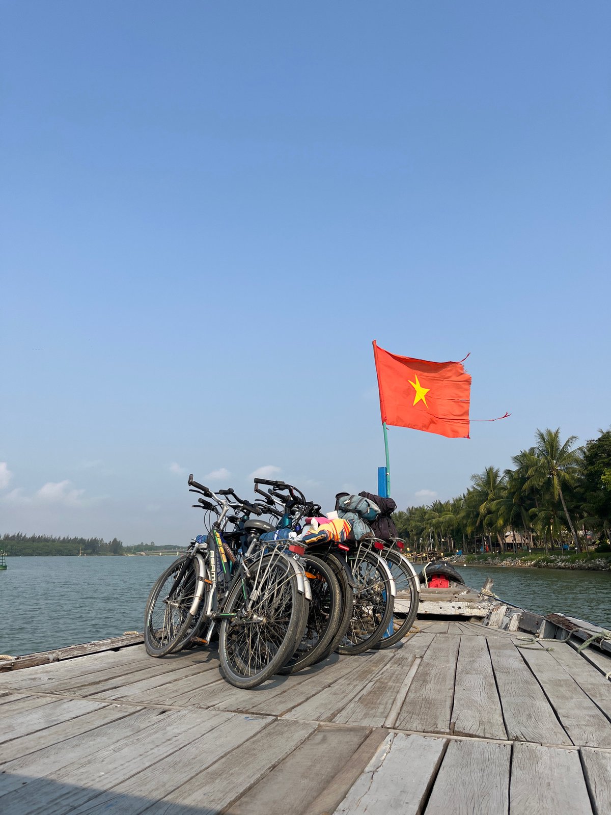 Bicycles transported on wooden boat deck in Hội An