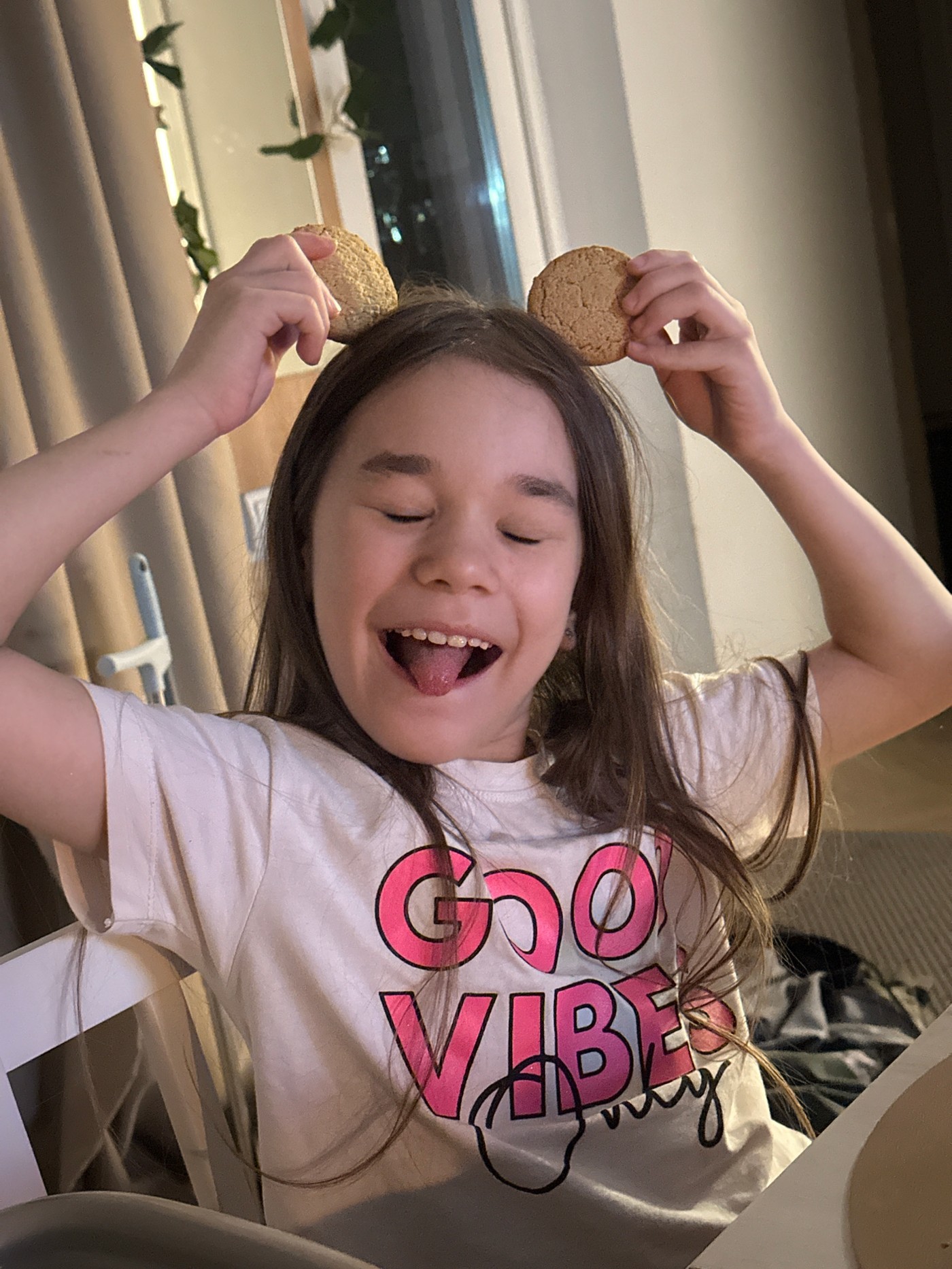 Girl enjoys playful cookie snack time in Kharnavy home