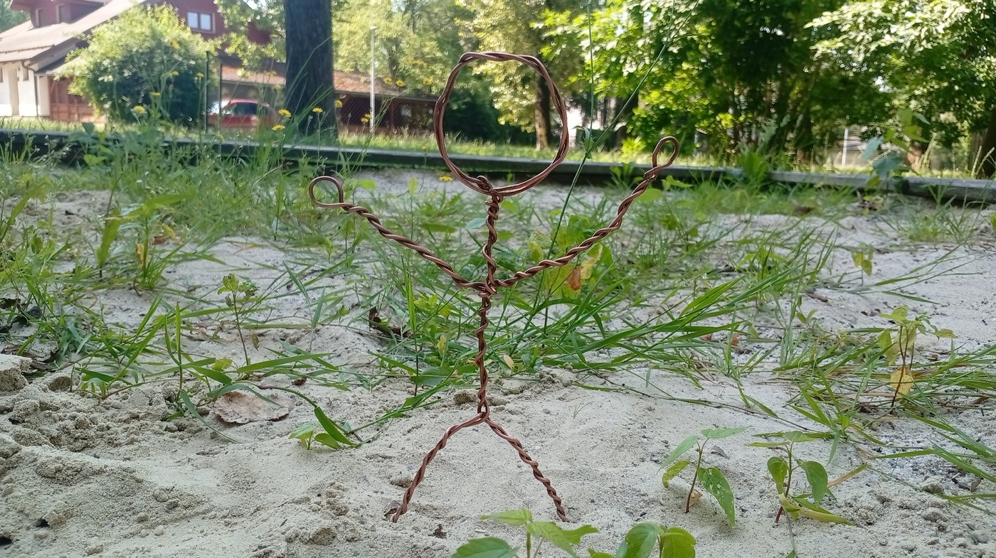 Handmade wire figure planted in sandy ground, Karviná