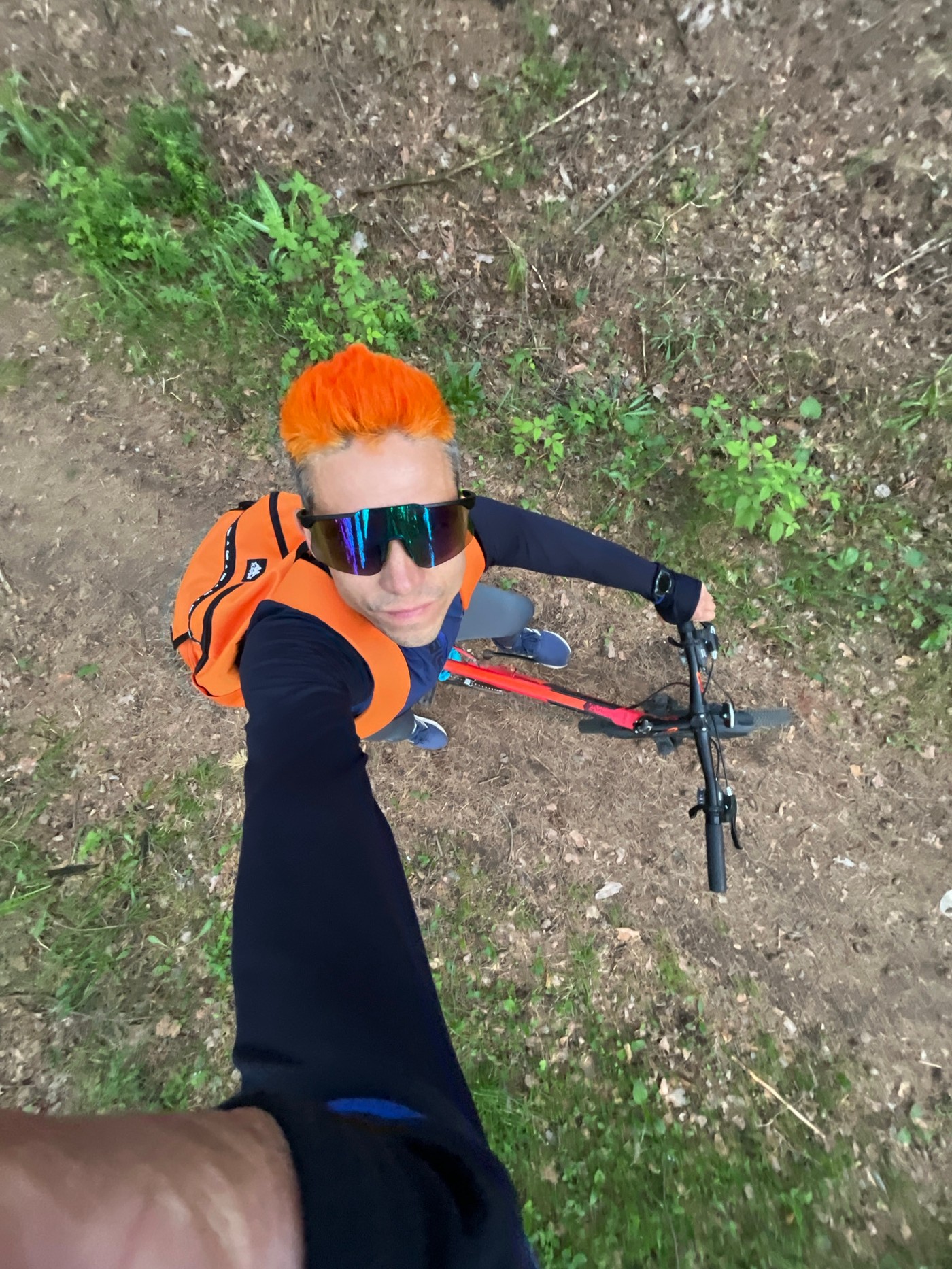Orange-haired cyclist photographed during woodland outing in Chaikovsky, Russia