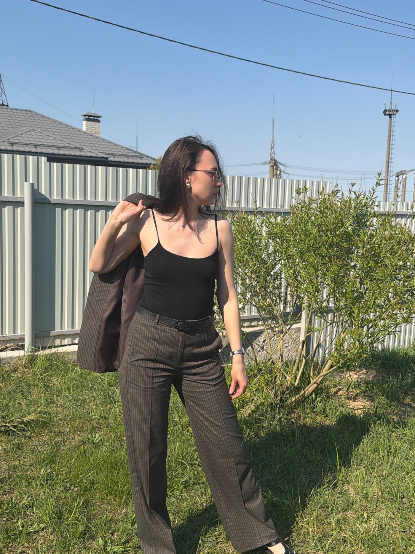 Woman photographed in pinstripe suit around Chaikovsky, Russia