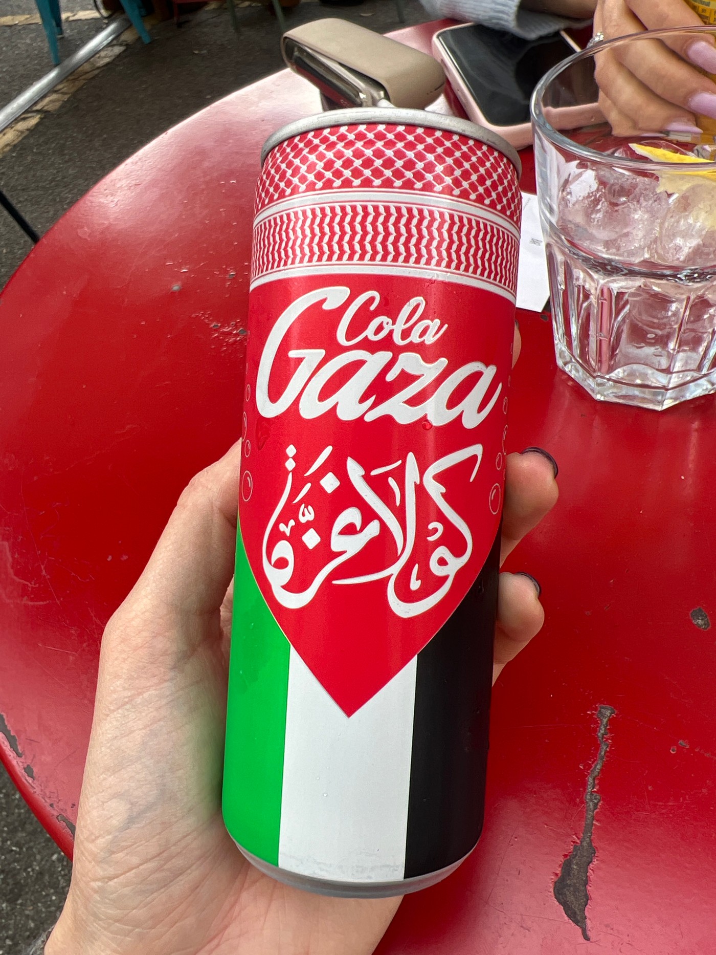 Person holds Palestinian-colored can in Milan