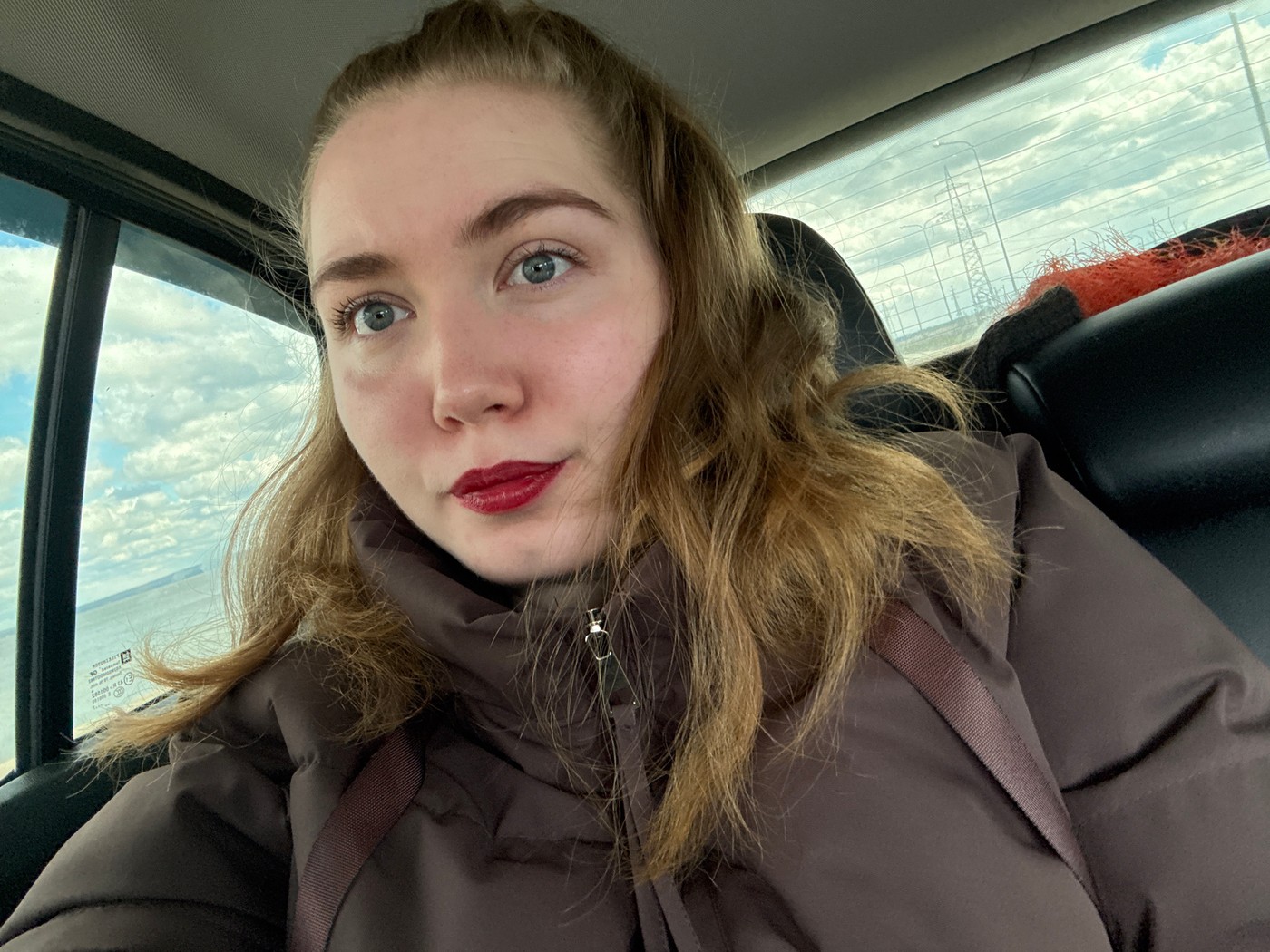 Woman takes selfie in car in Noviy, Russia