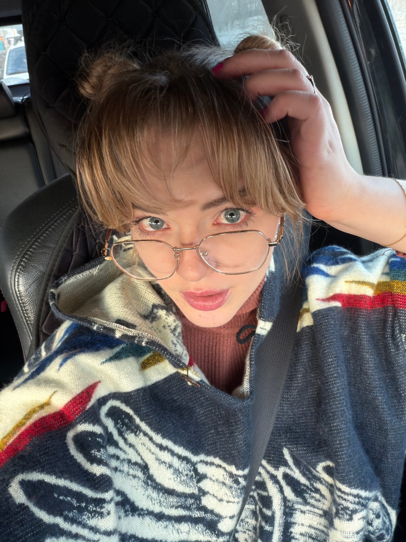 Woman takes selfies in car passenger seat in Russia