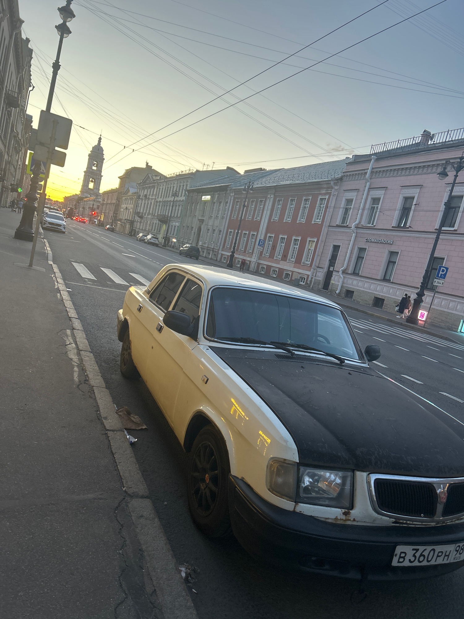 Evening street scene in a European city with ornate architecture