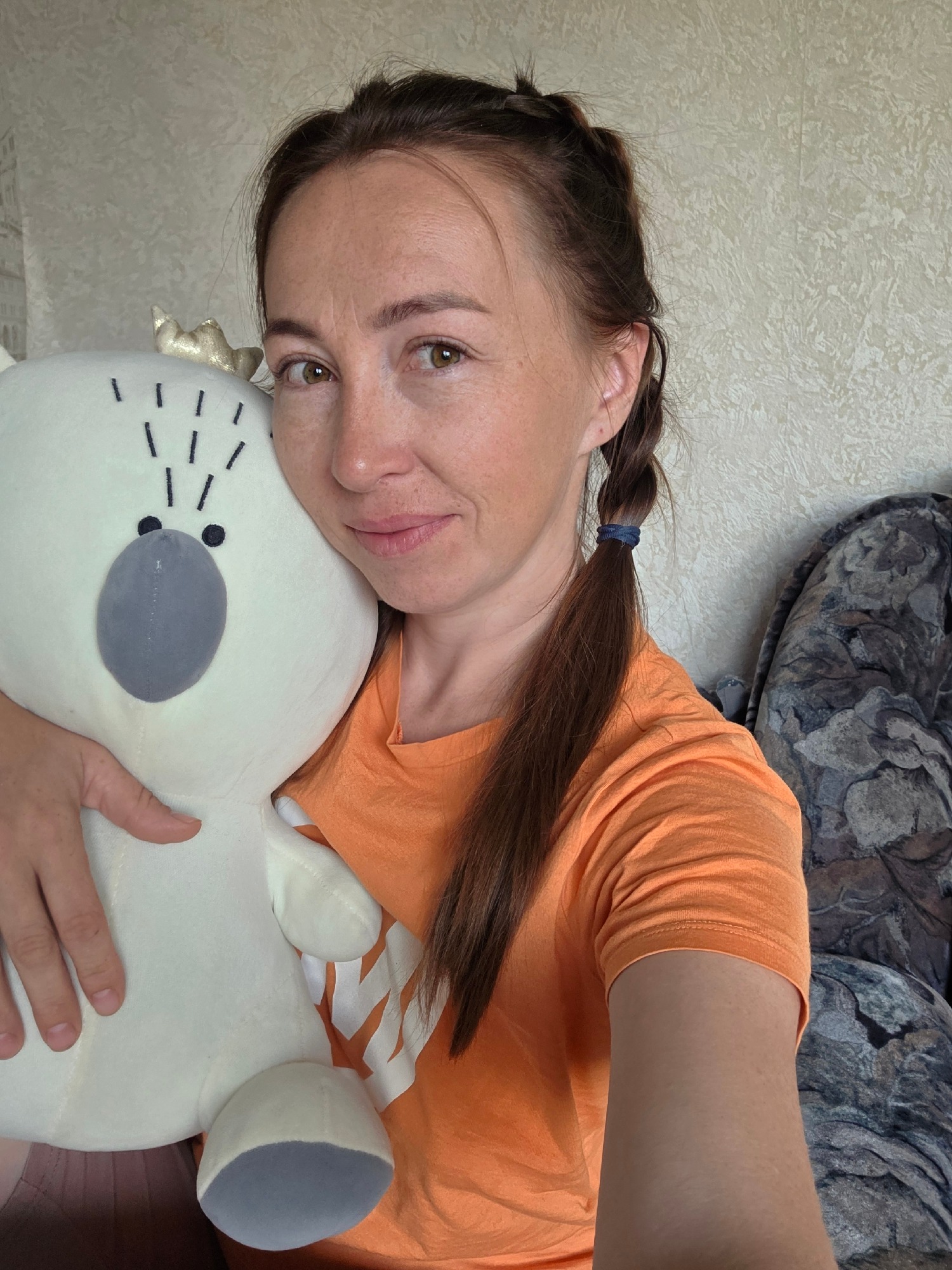 Casual snapshots featuring a white stuffed animal and a selfie