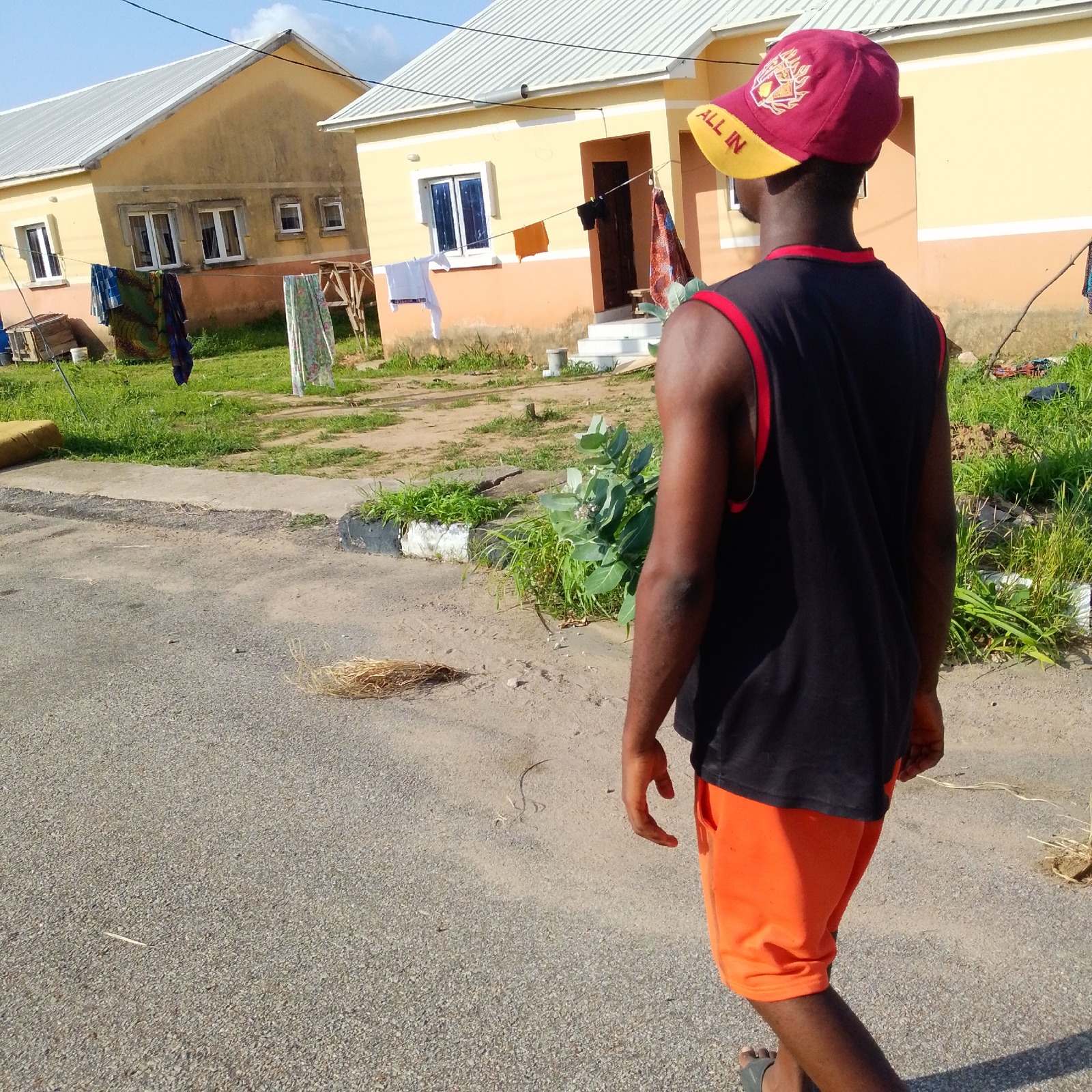 Walking through a semi-rural African neighborhood, roads to farmland