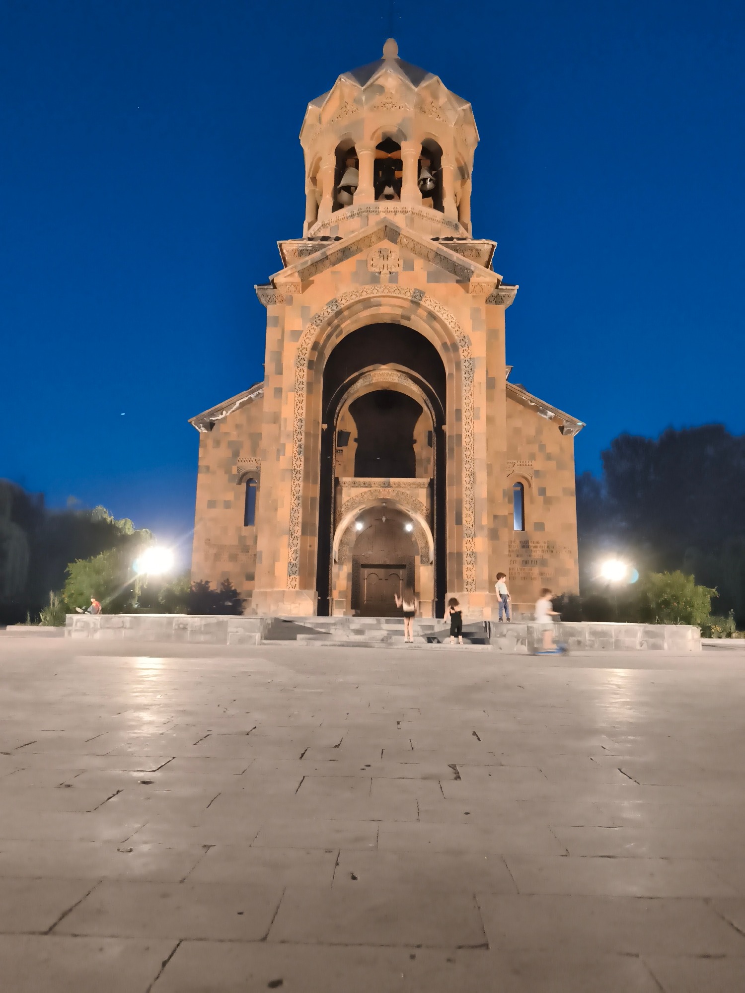 Armenian church and monument lit up on a June evening