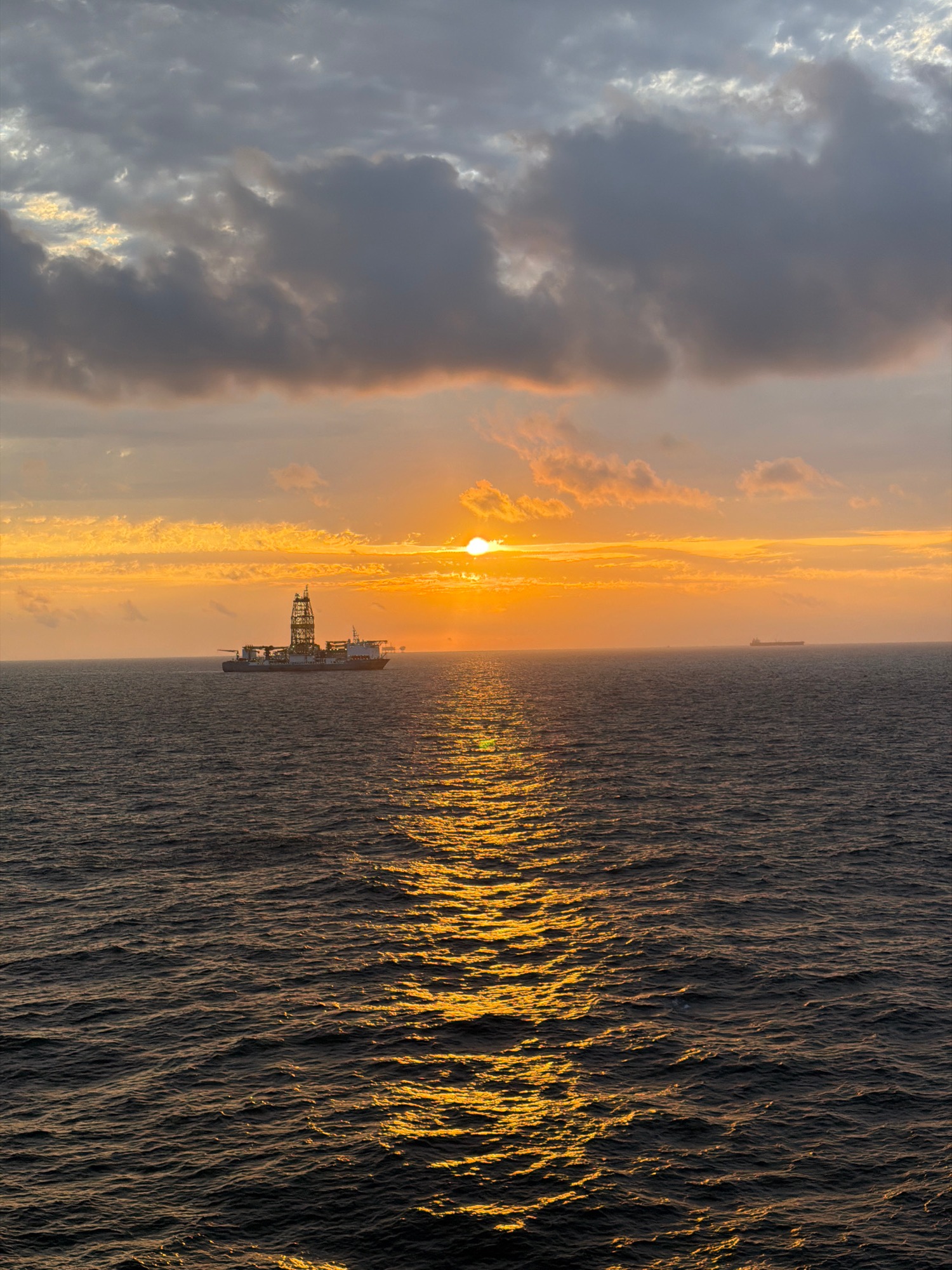 Gulf sunset observed from vessel shows dramatic skies