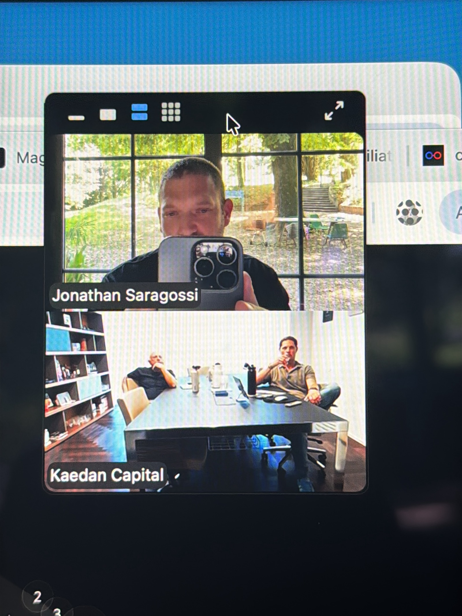 Three-way video call, one participant shooting a selfie outdoors