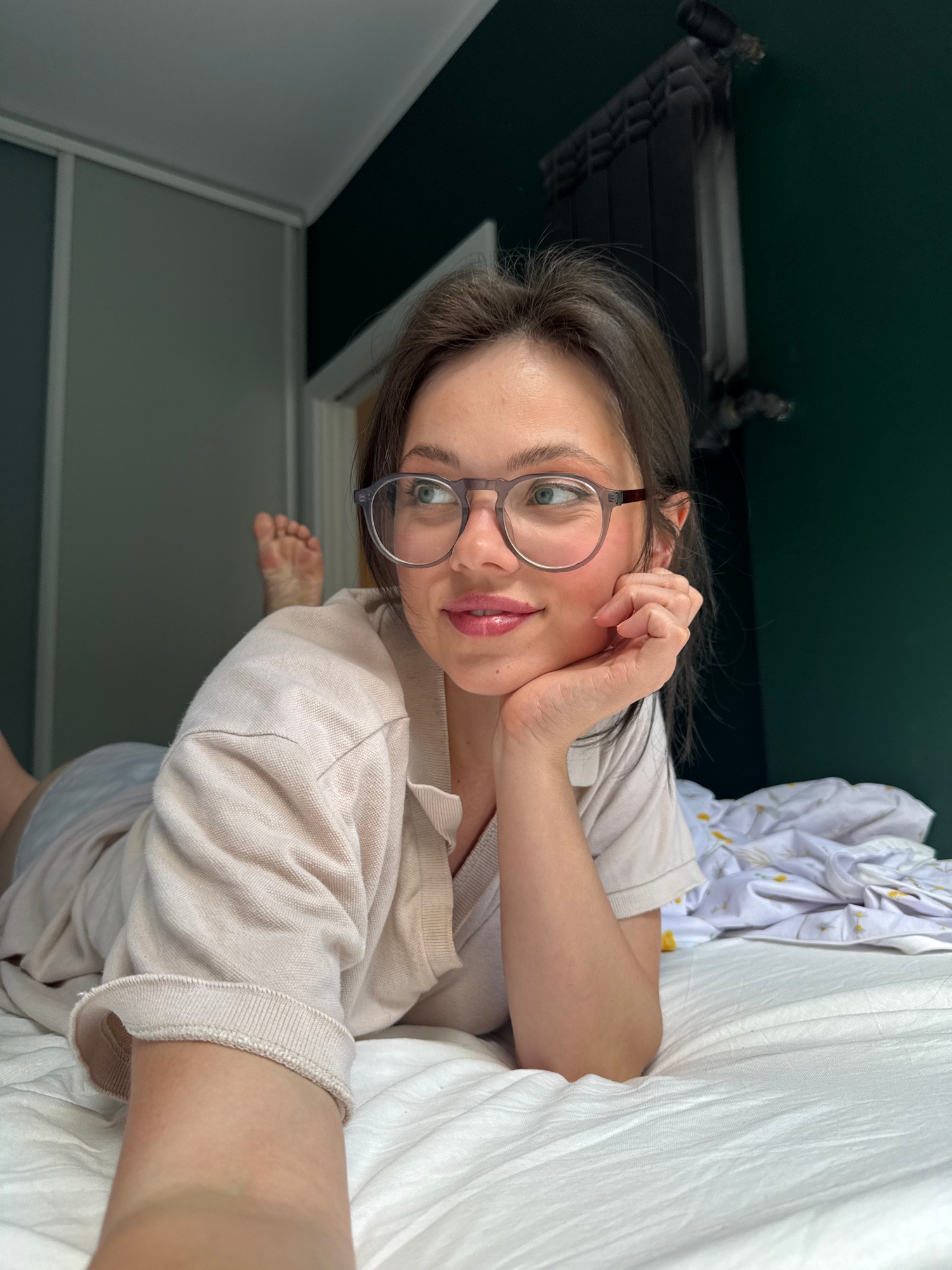 Casual selfie session on white sheets, glasses and polo.