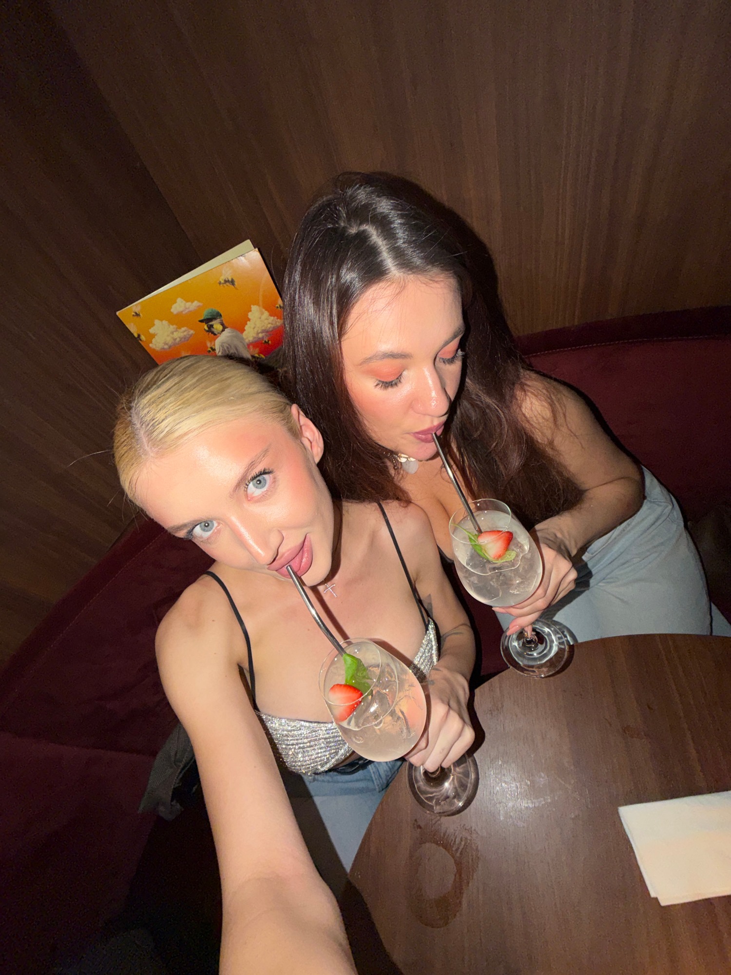 Toasting the Night: Friends and Cocktails in a Dimly Lit Lounge.