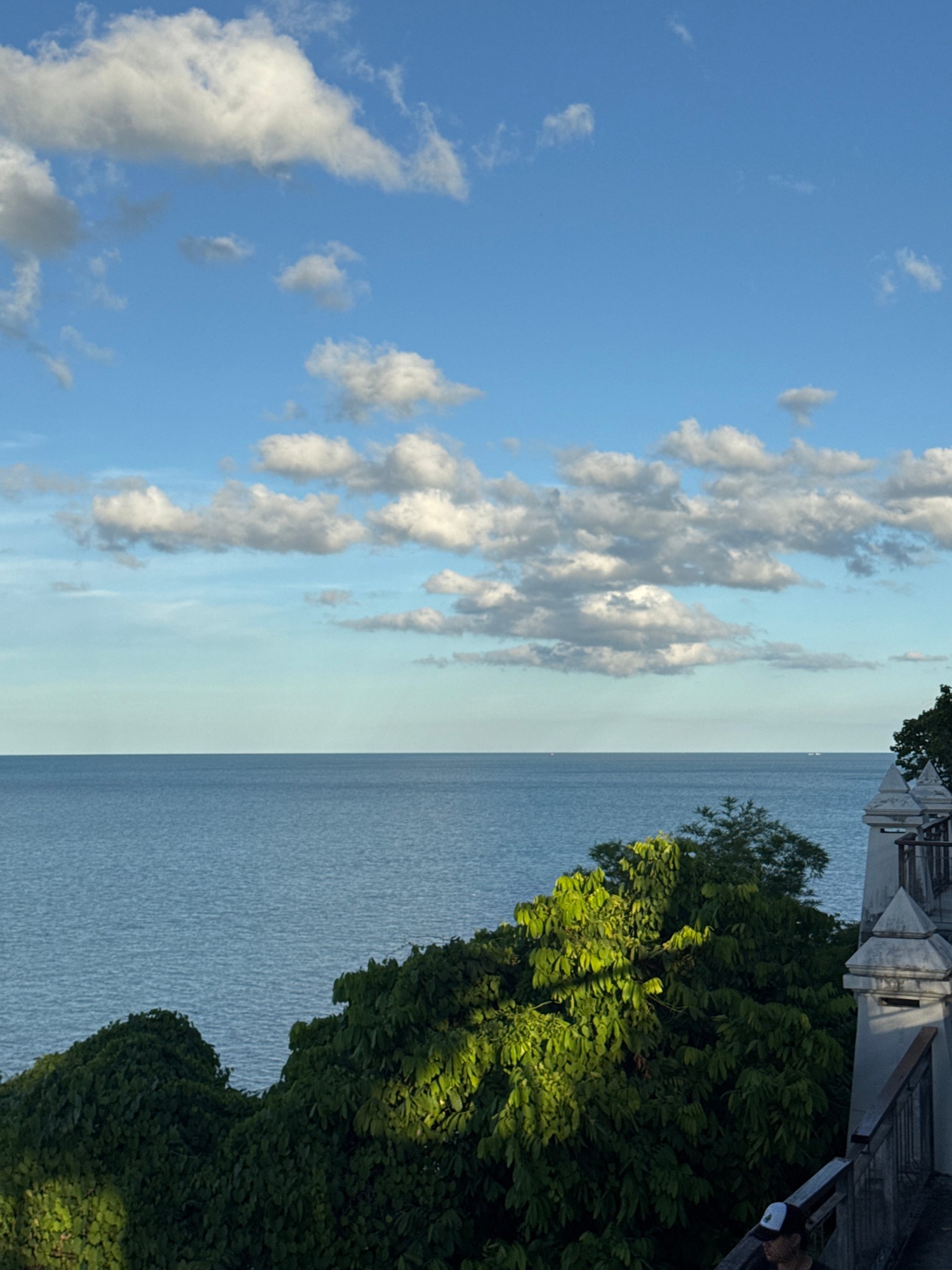 Morning stroll along a tropical clifftop walkway with ocean views