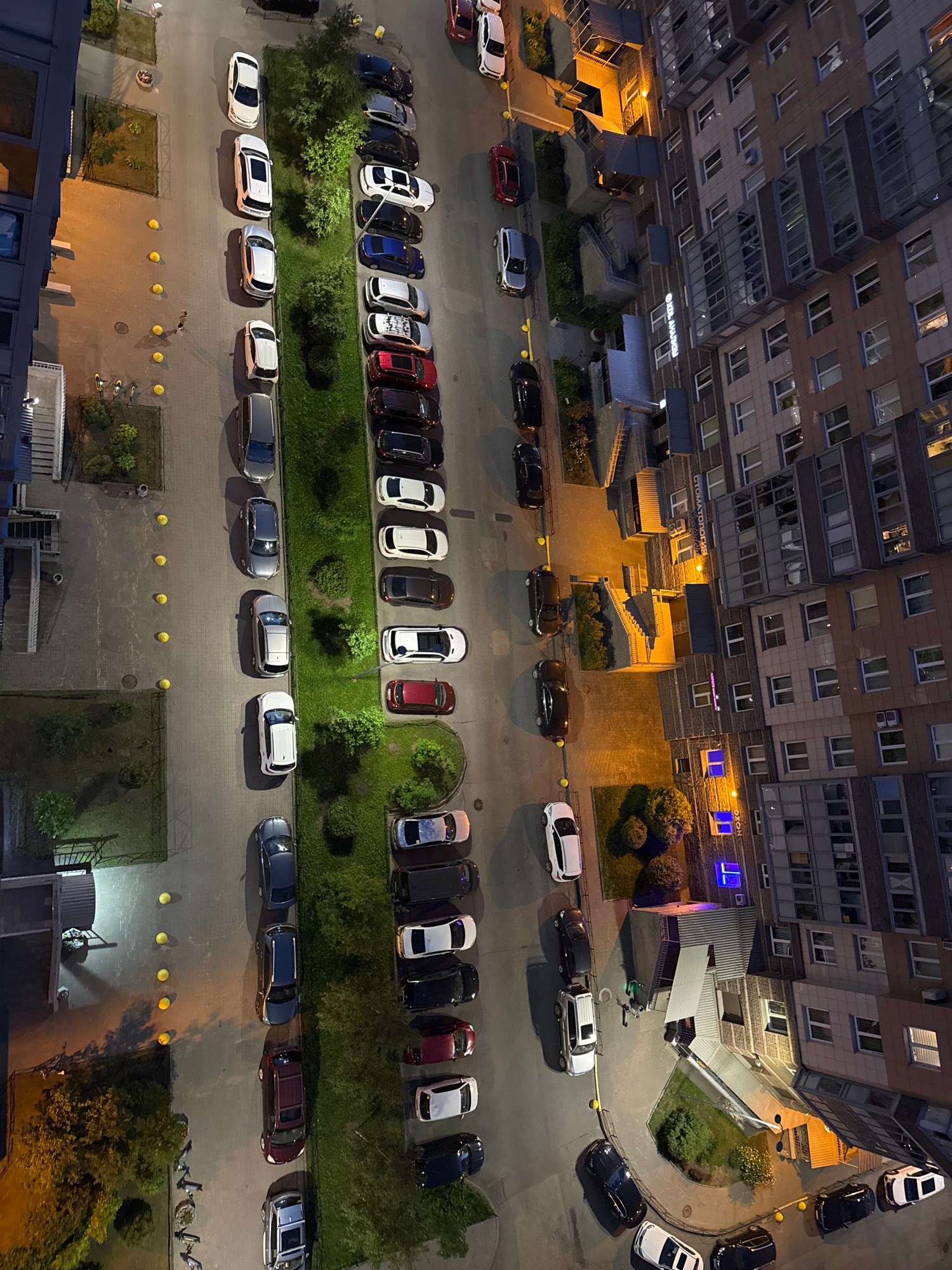 City buildings and a lit tower at dusk from above